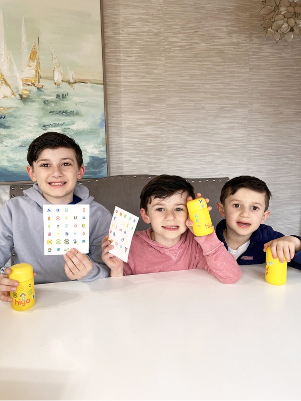 kids holding hiya vitamins decorating bottle